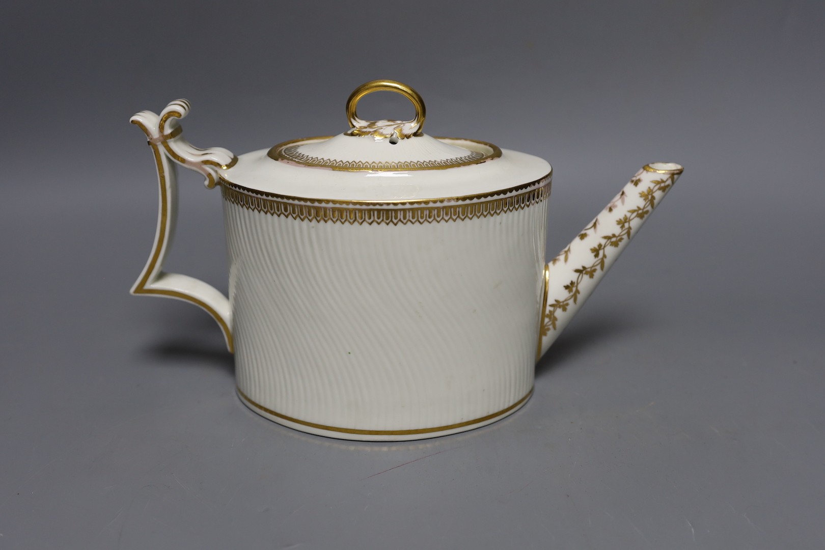 A Derby puce mark teapot and cover, late 18th century, with wavy parallel moulding with ornate gilded decoration, pattern to base. 26cm